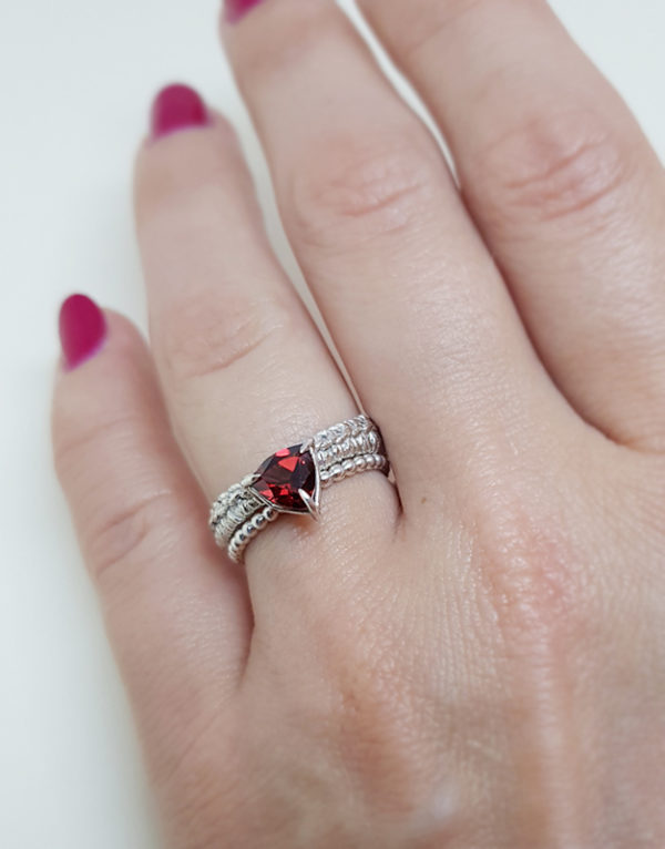 sterling silver ring with garnet trillion cut gemstone