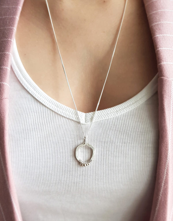 stylish simple silver pendant with gold droplets