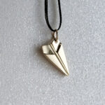 Paper plane pendant in 14K gold